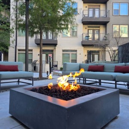 a fire pit with chairs nearby