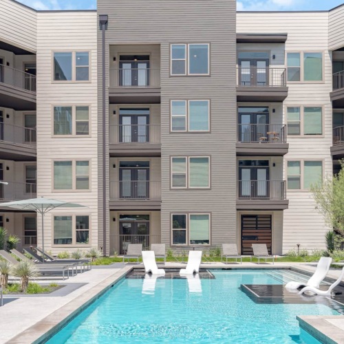 Resort-style swimming pool with lounge seating
